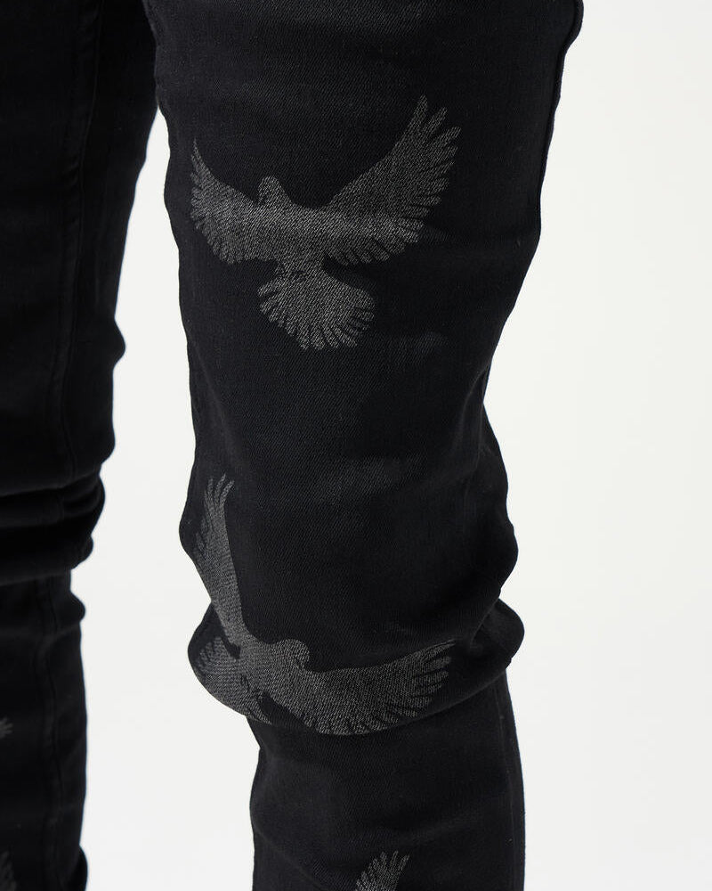 Black jeans with eagle embroidery on a white background