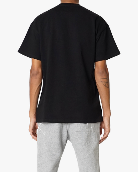 Person wearing a black t-shirt and gray pants on a white background