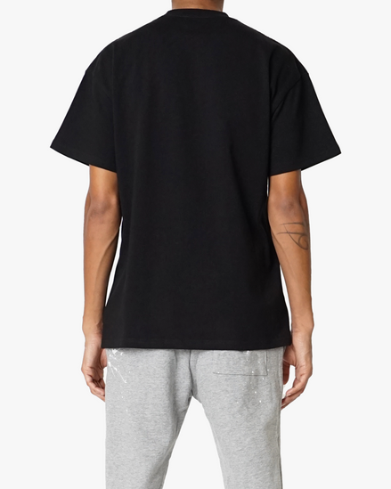 Person wearing a black t-shirt and gray pants on a white background