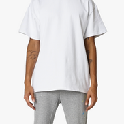 Person wearing a white t-shirt and gray pants on a white background