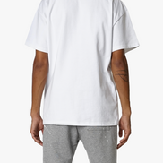 Person wearing a plain white t-shirt and gray pants on a white background