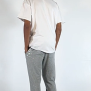 Person wearing a white t-shirt and gray pants with black accents on a white background