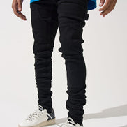 Person wearing black pants and white sneakers on a white background