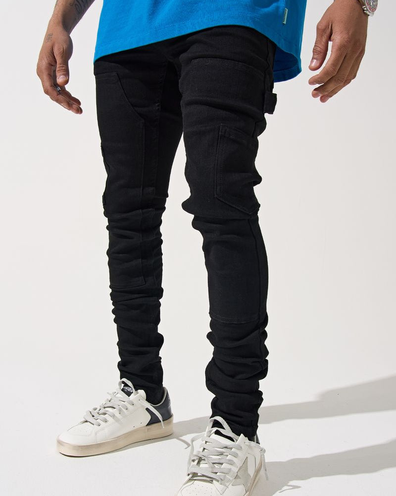 Person wearing black pants and white sneakers on a white background