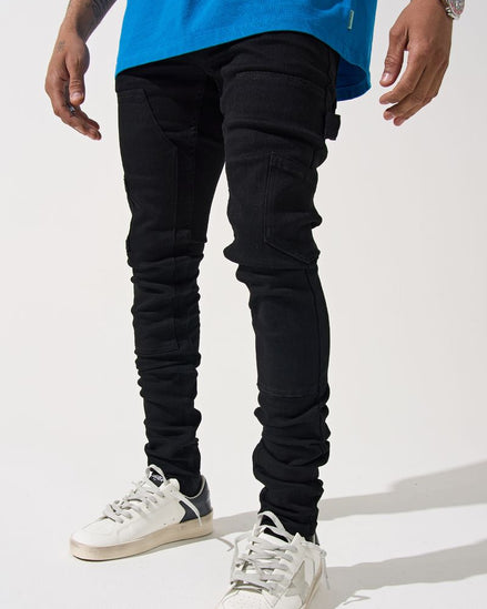 Person wearing black pants and white sneakers on a white background