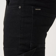 Close-up of black pants with a brand label on a white background