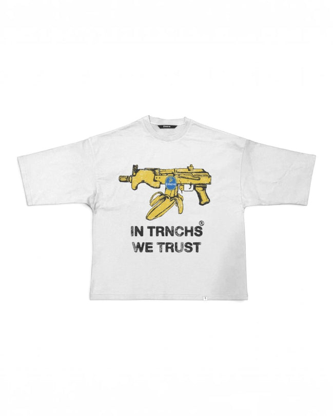 A white short-sleeve t-shirt with a graphic of a yellow assault rifle and a bullet, with the text 'IN TRNCHS WE TRUST' printed below in black.