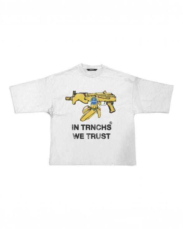 A white short-sleeve t-shirt with a graphic of a yellow assault rifle and a bullet, with the text 'IN TRNCHS WE TRUST' printed below in black.