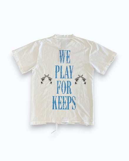 White shirt with blue text 'WE PLAY FOR KEEPS' on a white background
