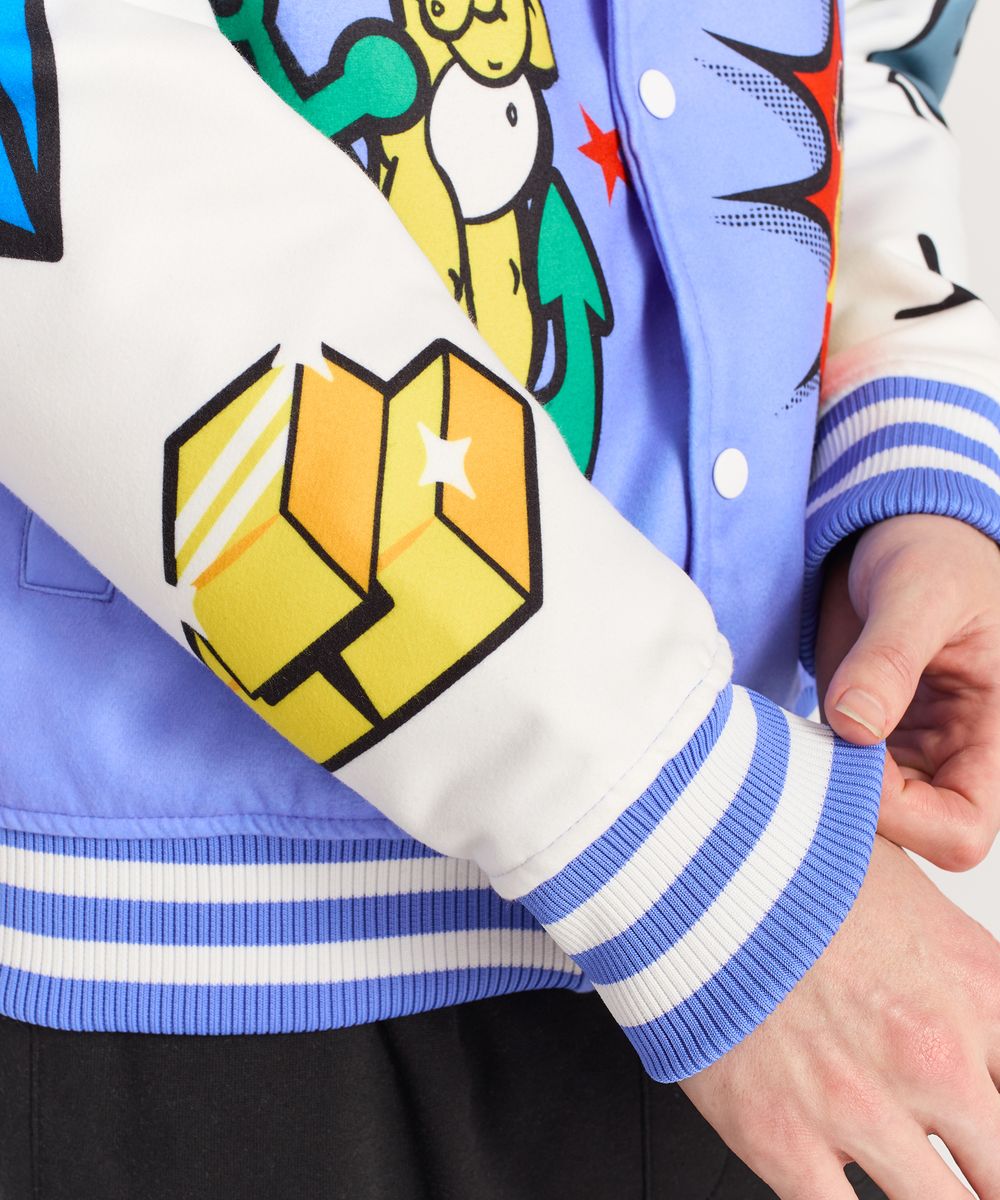 Colorful jacket with geometric design and cartoon character on sleeve