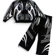 A black two-piece athletic tracksuit featuring a zip-up jacket and matching pants, both decorated with bold silver and white flame graphics and text.