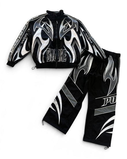 A black two-piece athletic tracksuit featuring a zip-up jacket and matching pants, both decorated with bold silver and white flame graphics and text.