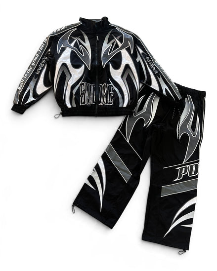 A black two-piece athletic tracksuit featuring a zip-up jacket and matching pants, both decorated with bold silver and white flame graphics and text.