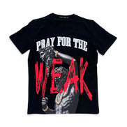 A black short-sleeve graphic t-shirt featuring a printed design of a man with gold chains and the text 'PRAY FOR THE WEAK' in white and distressed red lettering.