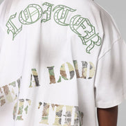 White t-shirt with green and multicolor text on a plain background