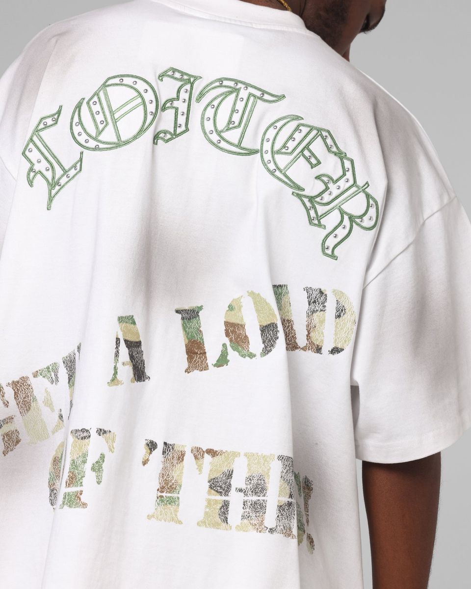 White t-shirt with green and multicolor text on a plain background