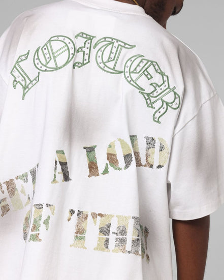 White t-shirt with green and multicolor text on a plain background