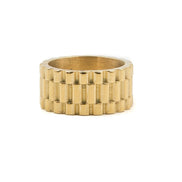 close up of the gold presidential ring on a blank white background 