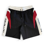 Black shorts with red and white accents on a white background
