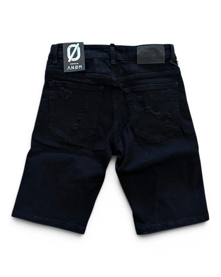 Black shorts with a brand label on a white background