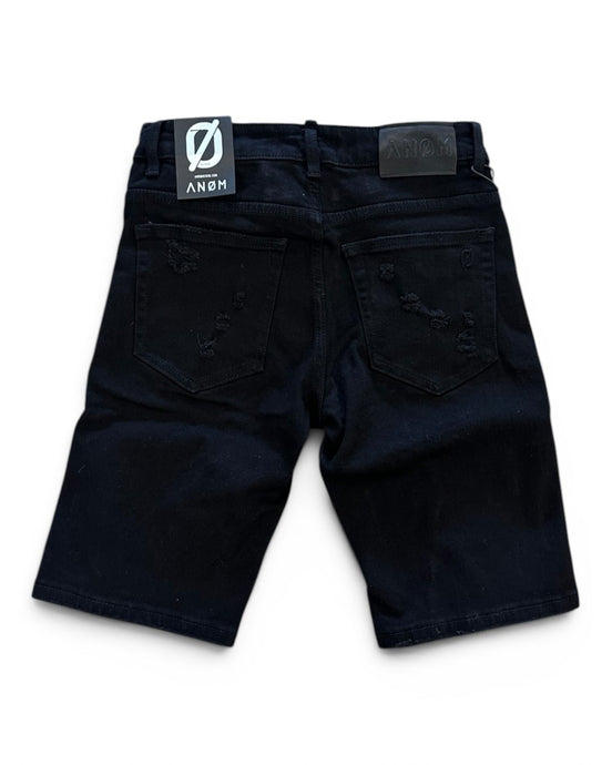 Black shorts with a brand label on a white background