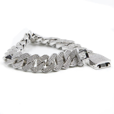 a close up of the prong cuban link bracelet  in silver on a white background