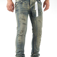 Person wearing distressed blue jeans with a visible brand tag on a white background