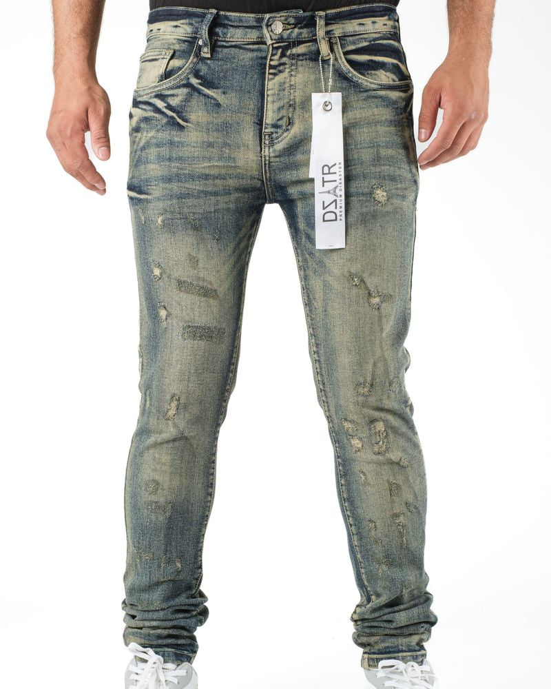Distressed blue jeans with a visible brand label on a white background