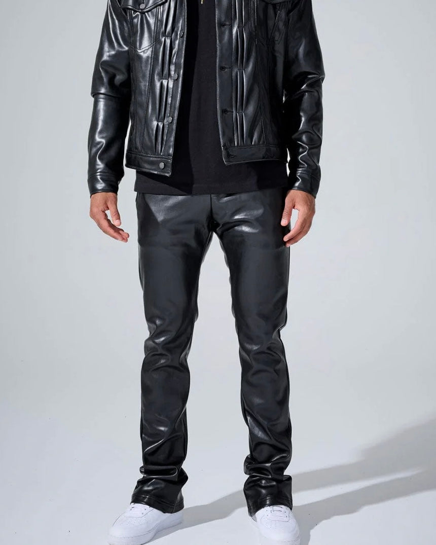 Person wearing a black leather jacket and pants on a white background