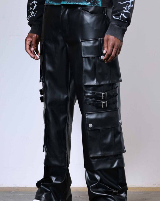 Person wearing black leather pants with multiple pockets and a white background