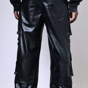 Black leather pants worn by a person against a plain background