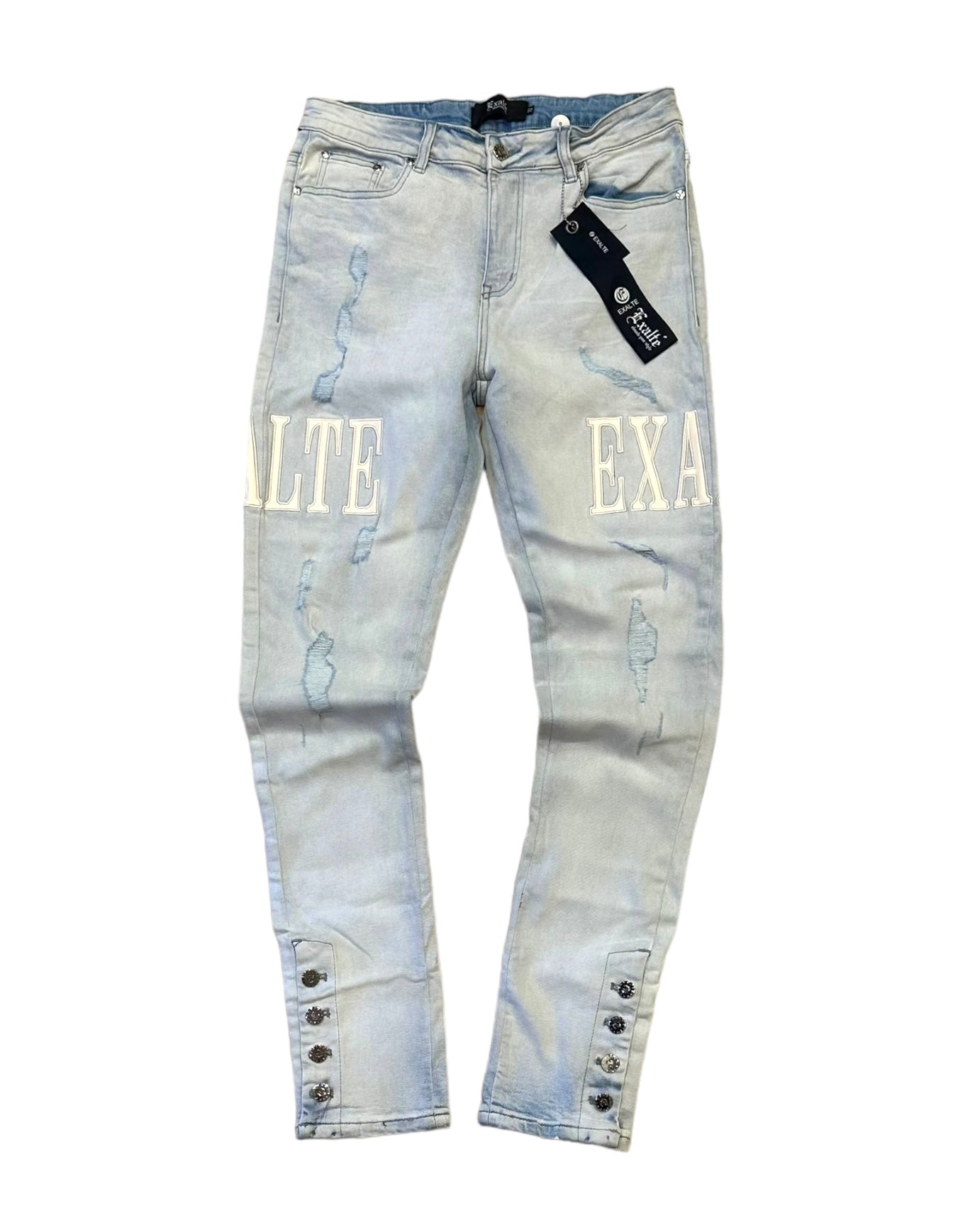 front view of the ice blue exlate jeans with the leather patches gleaming. You can see lightly distressed rips and the buttons at the bottom. 