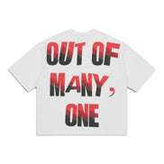 A white short-sleeve t-shirt shown from the back, featuring the text 'OUT OF MANY, ONE' printed in a bold black-to-red gradient font.
