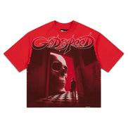 A red short-sleeve t-shirt featuring a large graphic print on the front. The graphic displays the 'Godspeed' band logo in stylized white script above a dark red scene of a skull in a doorway with a silhouetted figure standing in front of it.