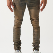 Person wearing brown leather pants and white sneakers on a white background