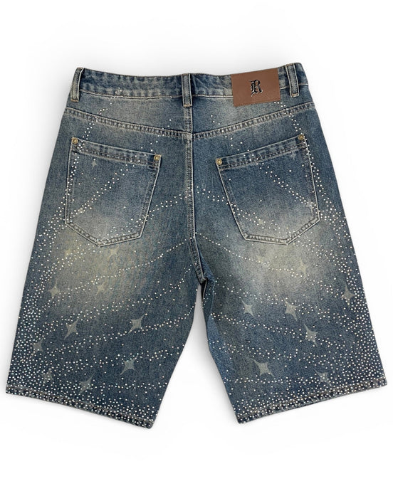 Blue denim shorts with star patterns on a white background