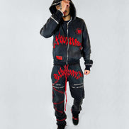 Person wearing a black hoodie and pants with red text on a white background