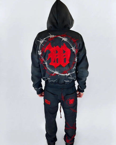 Black hoodie and pants with red design on a white background