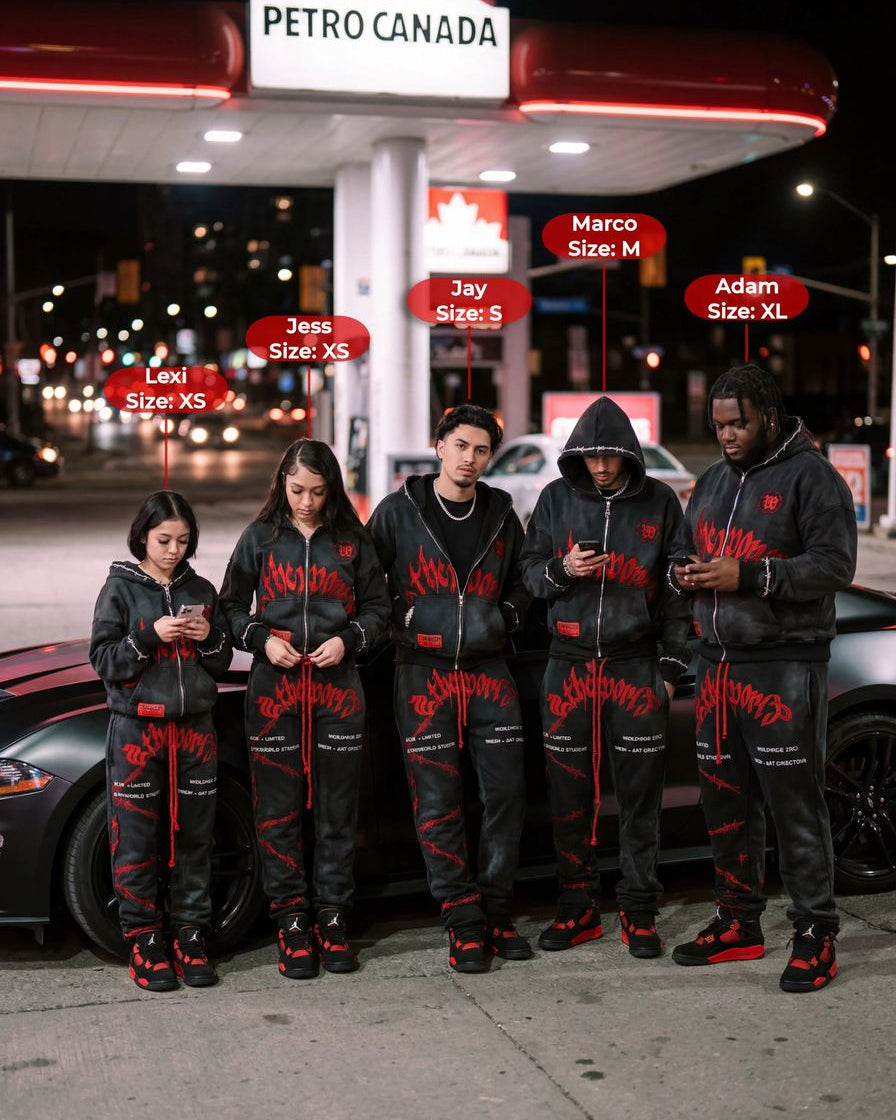Five people wearing matching black outfits with red accents standing in front of a Petro Canada gas station at night.