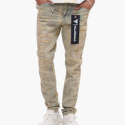 Person wearing beige distressed jeans with a brand label on a white background