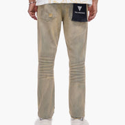 Person wearing beige pants and a white shirt with gold designs on a white background
