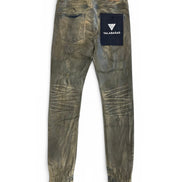 Worn green jeans with a visible brand logo on a white background