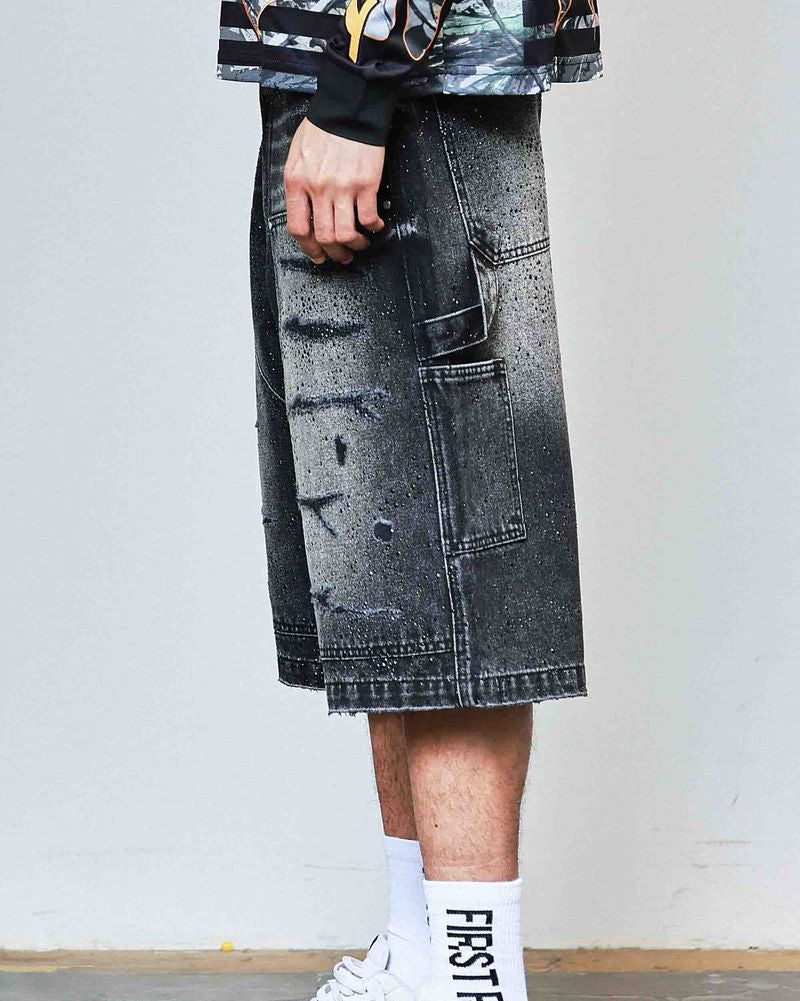 Person wearing a black and white outfit with a denim skirt and sneakers.