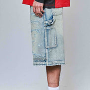 Person wearing a red jacket, light blue denim shorts, and white sneakers with black Nike logo.