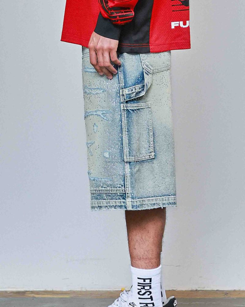 Person wearing a red jacket, light blue denim shorts, and white sneakers with black Nike logo.