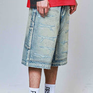 Person wearing a red jacket, denim shorts, white sneakers, and socks with text.