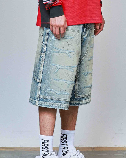 Person wearing a red jacket, denim shorts, white sneakers, and socks with text.
