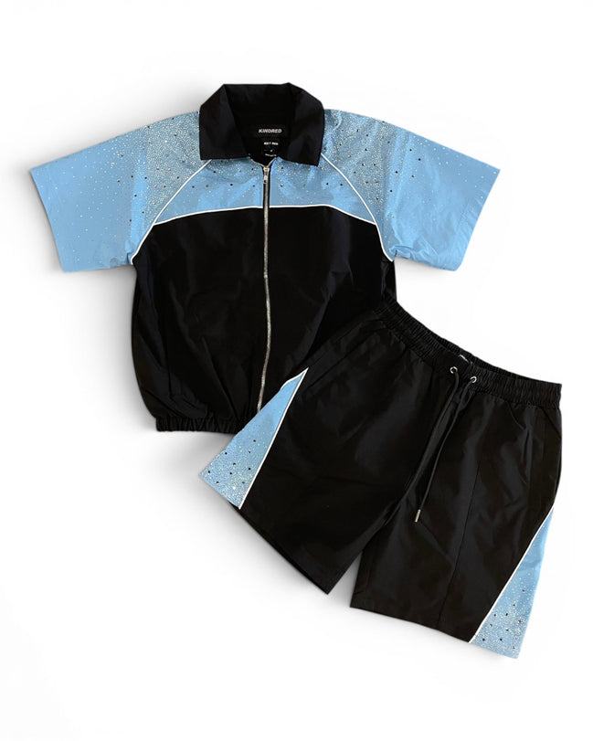 Black and blue tracksuit with a white background