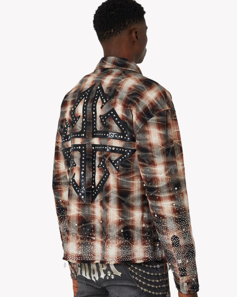 Person wearing a plaid shirt with decorative elements on a white background
