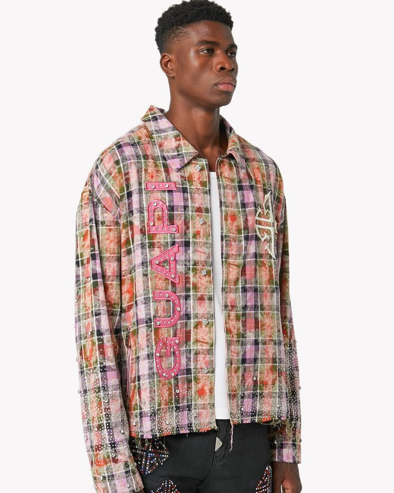 Man wearing a colorful plaid shirt with text and black pants on a white background